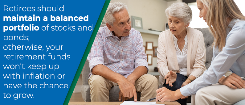 Retirees should maintain a balanced portfolio of stocks and bonds; otherwise your retirement funds won't keep up with inflation or have the chance to grow. -  Elderly couple sitting with a younger woman looking over paperwork