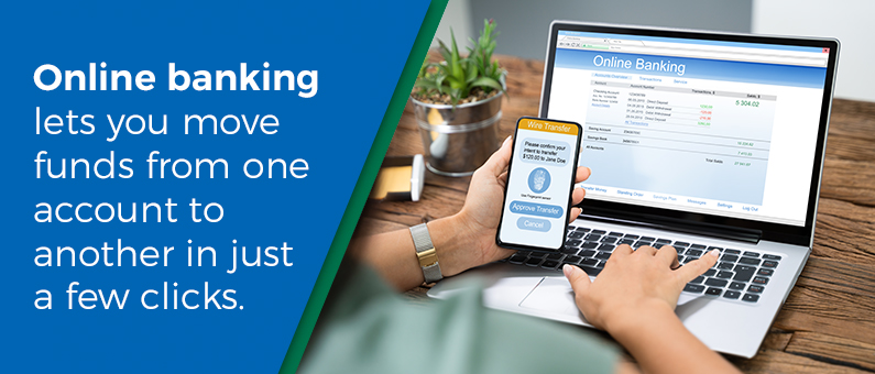 Online banking lets you move funds form one account to another in just a few clicks - Woman at a laptop looking at a wire transfer screen, holding her phone with wire transfer info