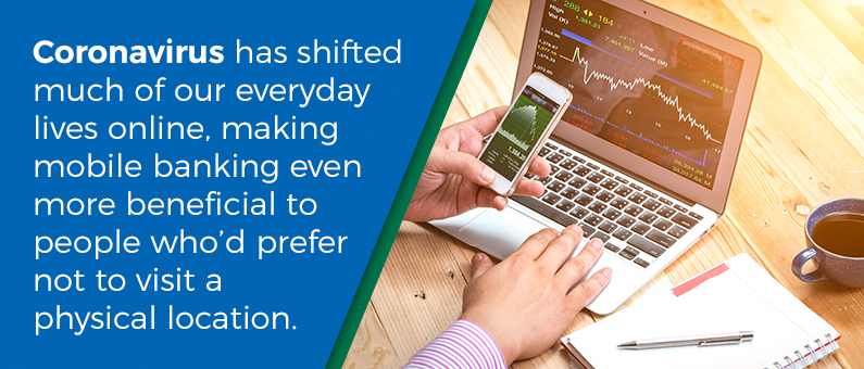 Coronavirus has shifted much of our everyday lives online, making mobile banking even more beneficial to people who'd prefer not to visit a physical location -  close up a person typing on a laptop with a coffee cup pen and notebook nearby 