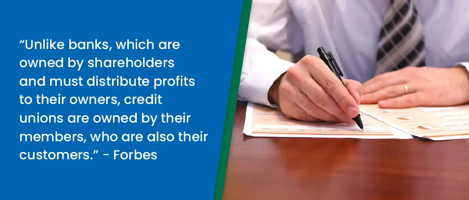 A person signs a document at a desk. Text beside explains credit unions are owned by members, unlike banks, which are owned by shareholders.