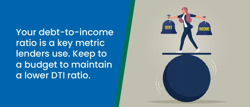 A person balances on a large ball holding weights labeled Debt and Income, with text explaining the importance of a low debt-to-income ratio for lenders.